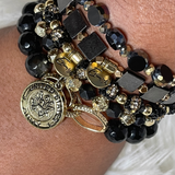 This stack was designed in honor of all of our Local Heroes! This Army Stack displays a variety of black and gold beads and is highlighted with a golden Army charm.