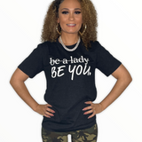 Nice everyday T-Shirt that says be a lady with a line through it and then underneath it says Be You